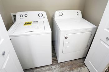 A washer and dryer sit next to each other in a laundry room